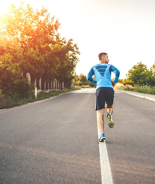 istock Fit young man running in sunset 595764322