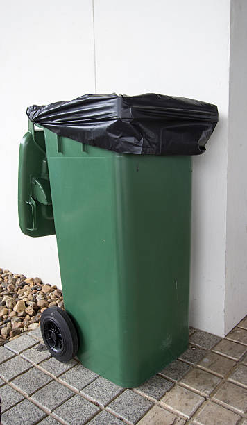 istock green garbage with black trash bags 595765574