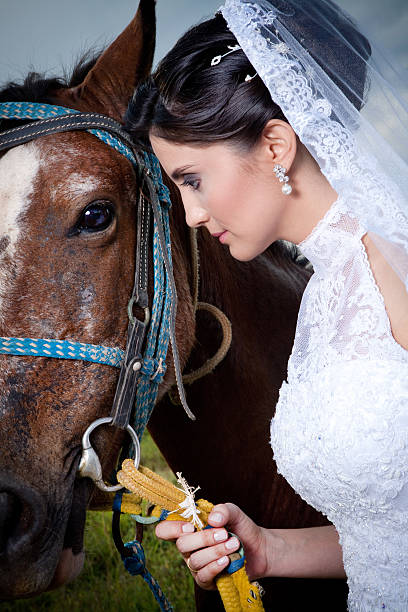 Close up view of a Beautiful Bride Looking at a Horse in a Farm