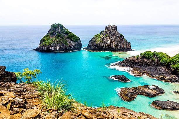 Two Brothers Island The classic view of Ilha Dois Irmãos in the archipelago of Fernando de Noronha with its intense colors highlighted by the sun over the sea. two brothers mountain stock pictures, royalty-free photos & images