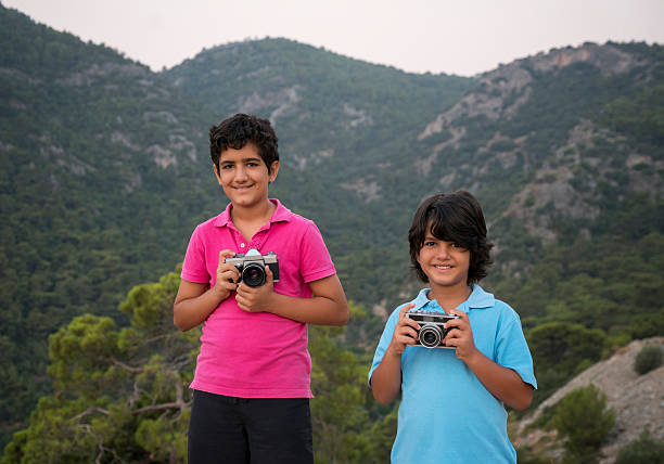Young boy photographers in nature, horizontal composition