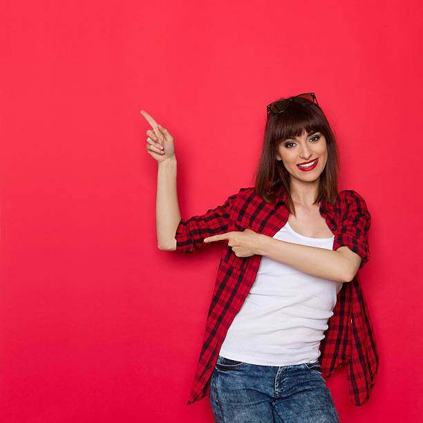 istock Young Woman Pointing At Red Copy Space 595767588