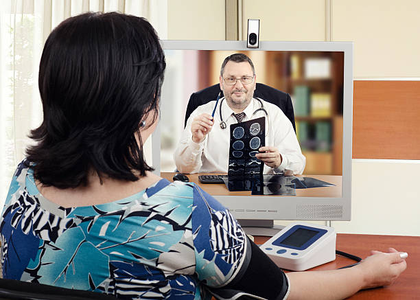 Male online cardiologist at work stock photo