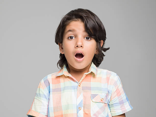 istock Young boy standing with a shocked face 595769240