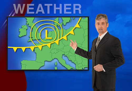 A tv television news weather meteorologist anchorman is reporting with a colorful European map and weather graphics on the monitor screen.