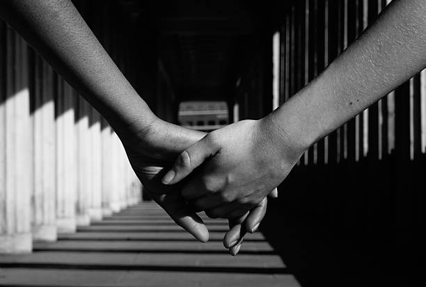 istock Cropped Image Of Holding Hands In Tunnel 595906455