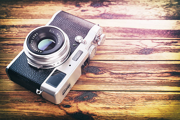istock Retro vintage camera on wood table background. 596040798
