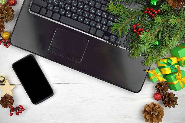 istock computer keyboard,smartphone and festive tinsel on a wooden background, 596040896