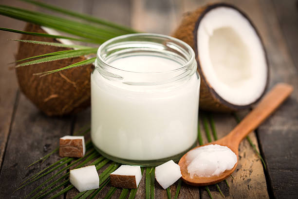 Coconut oil on the wooden table stock photo