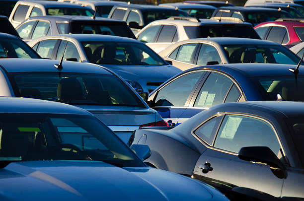 istock Sunrise over a packed automobile car parking sales lot 596042120