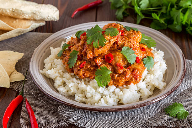 istock Chicken curry with rice and cilantro. 596042758
