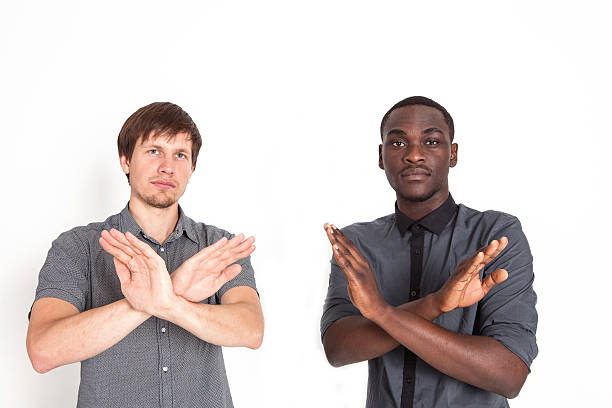 istock People of different nationalities show stop sign 596046762