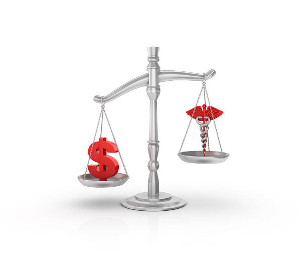 istock Scale with Dollar Sign and Medical Symbol 596049566