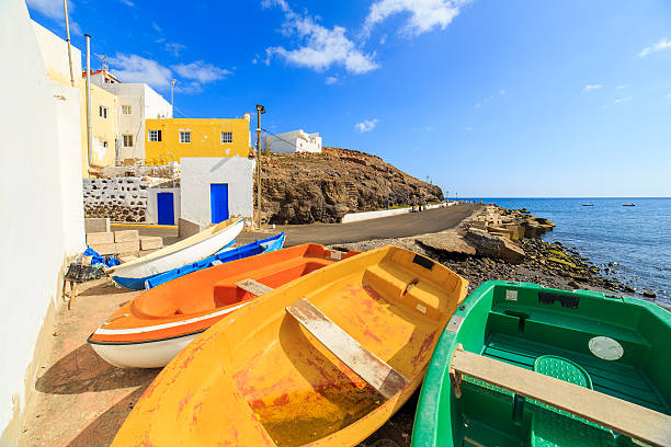 wooden fishing boats in a small port - lanzarote bay canary islands beach imagens e fotografias de stock