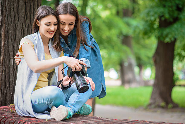 istock Pretty female friend looking at shots 596050902
