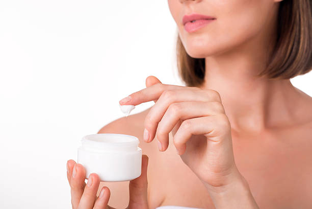 istock Young woman holding cream 596052088