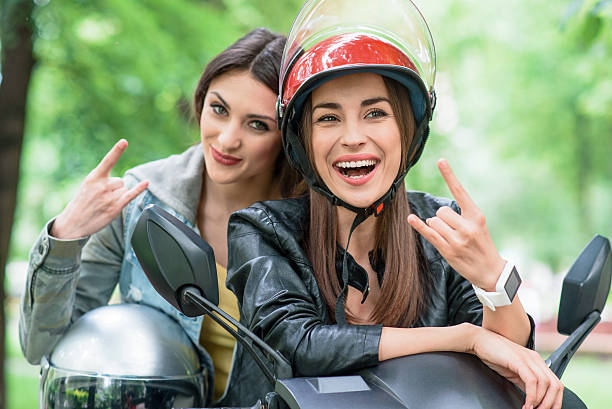 istock Cheerful young women gesturing on bike 596052338