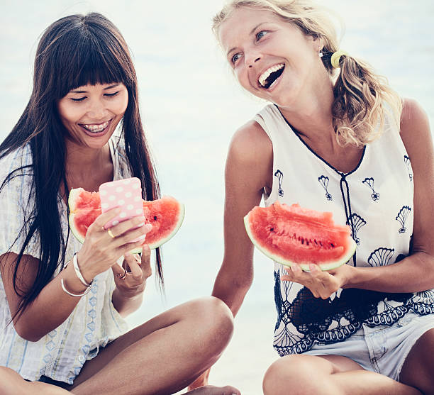 istock Two happy women enjoying a day on the beach 596054584
