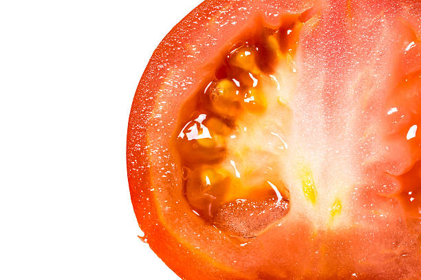 istock Core red fresh tomato cut in half close-up isolated 596058030