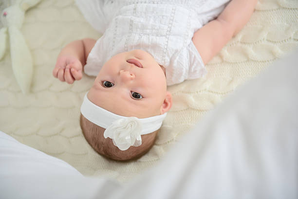 istock Cute baby lying on bed 596058098