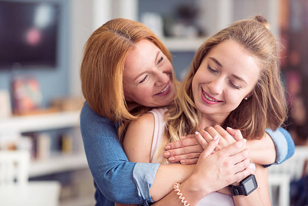 istock Cheerful mother and daughter embracing 596058406