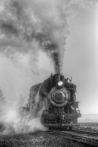 istock Black and white steam locomotive 596062660