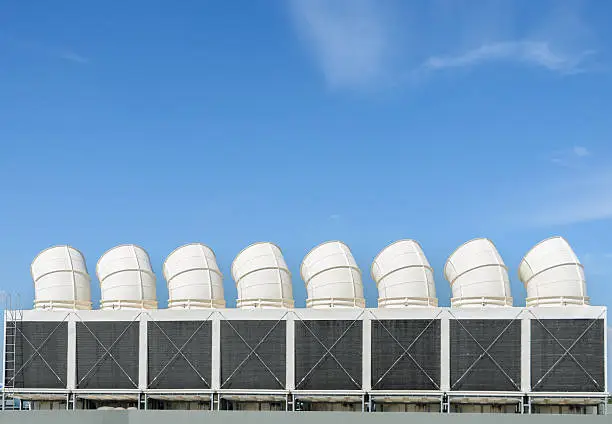 Industrial cooling towers or air cooled chillers on building rooftop