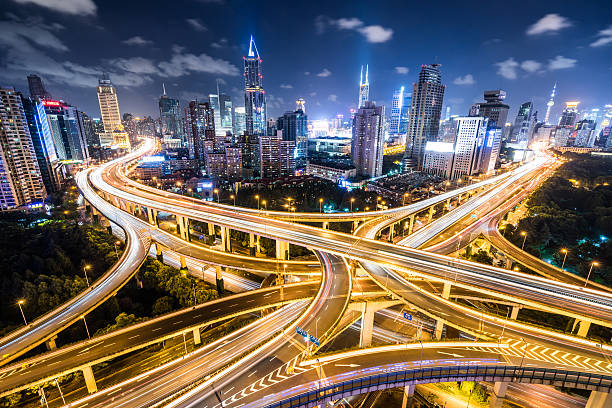 шанхай шоссе ночью - motion light built structure city стоковые фото и изображения
