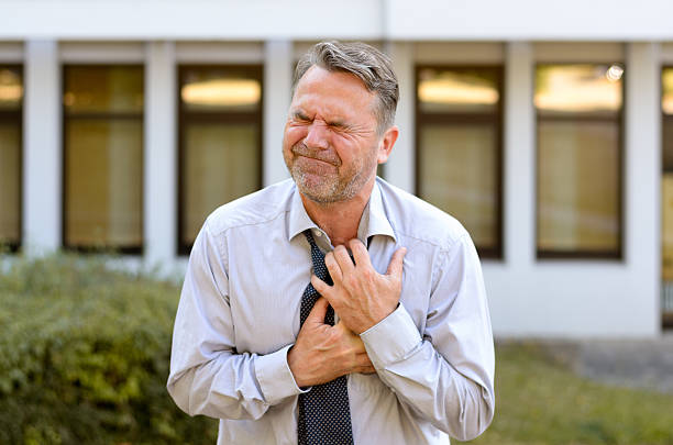 istock Middle-aged businessman suffering chest pains 596066054