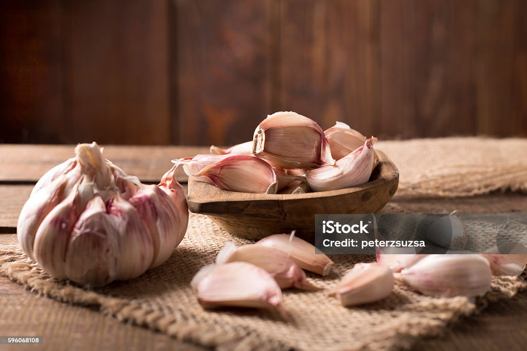 garlic garlic on canvas over wooden background Garlic Stock Photo