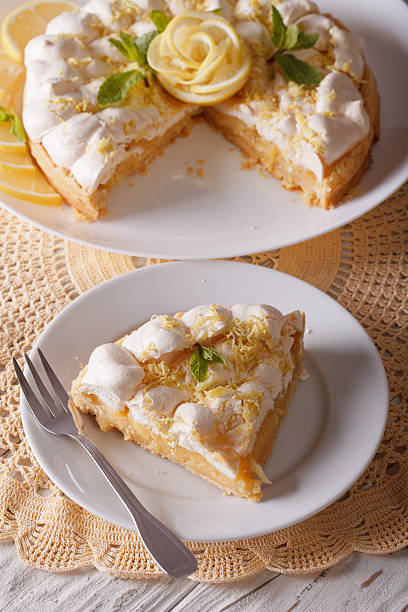 istock Delicious sliced lemon meringue cake close up on the table] 596068126