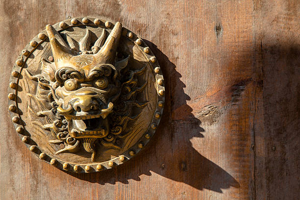 istock dragon door knocker on wooden gate 596068136