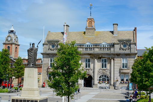 Crewe, United Kingdom - June 23, 2016: Crewe town hall / municipal building and war memorial, six members of the public can be seen, Crewe, Cheshire, UK