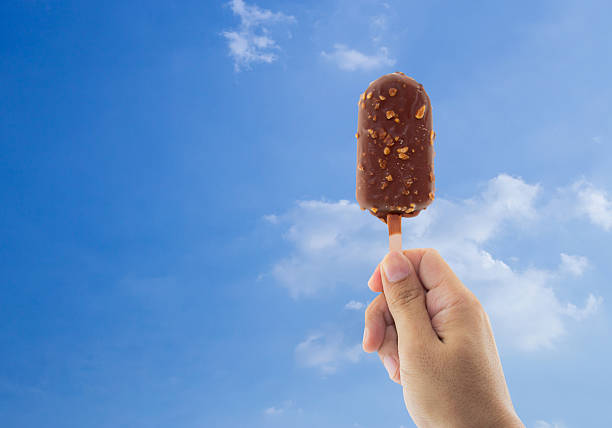 istock Ice cream held up to the summer sky 596070022