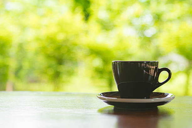 istock Black cup of coffee on table in cafe ,Morning light 596072742