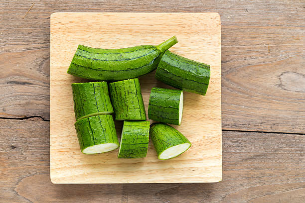 istock Snake gourd on wooden background 596074284