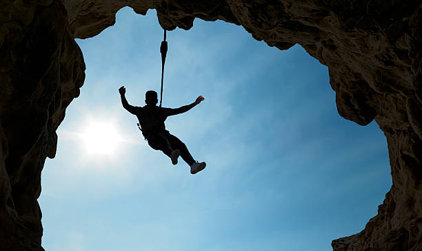 istock Silhouette of a climber over blue sky 596075746