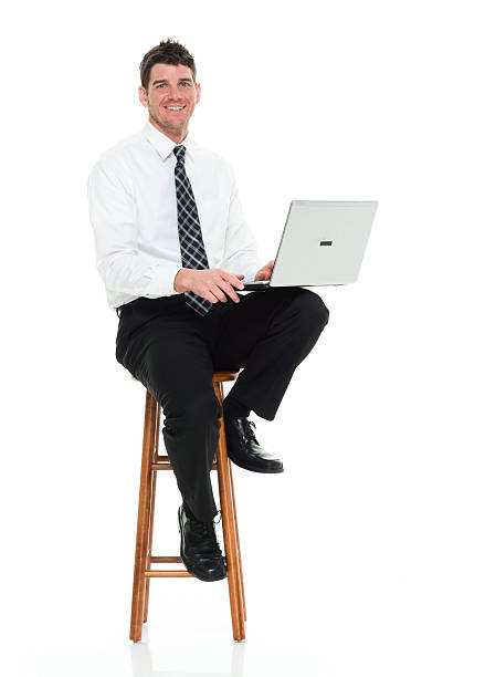 istock Smiling businessman working on laptop 596077232