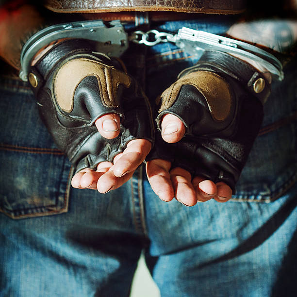 istock Criminal man. Male hands in handcuffs 596077476