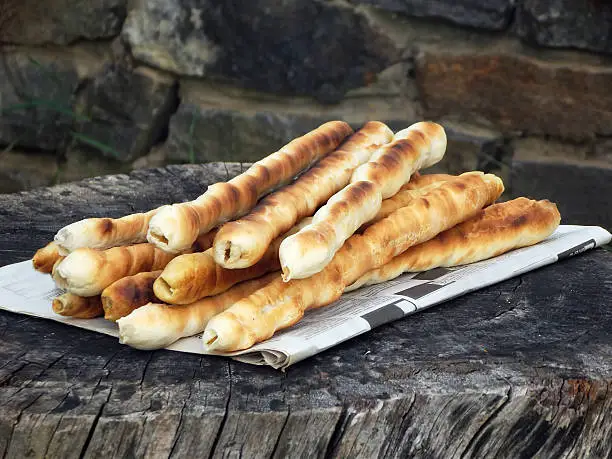 bread sticks of dough cooked on a fire. Italian breadsticks.