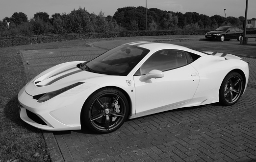 Lelystad, The Netherlands - August 27 2016: White Ferrari 458 Italia on a public parking lot in the city of Lelystad. Nobody in the vehicle.