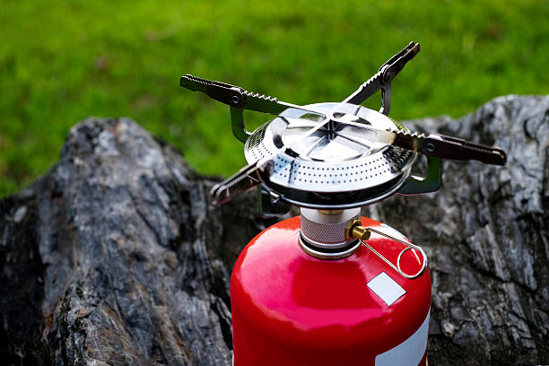Red Portable gas Camping stove on a rock (Backpack Concept) stock photo