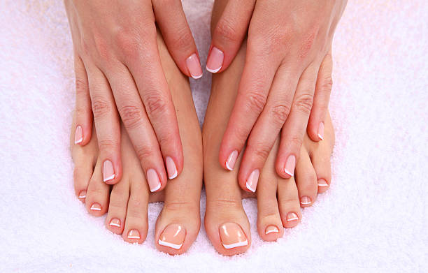 istock pedicure on legs and beautiful manicure  hands closeup 596080954