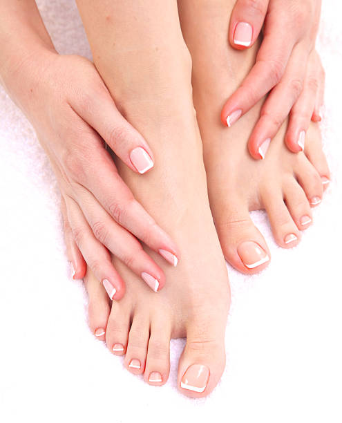 istock pedicure on legs and beautiful manicure  hands closeup 596081070