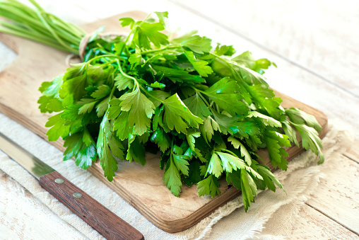 Organic italian parsley closeup on rustic wooden table, healthy vegetarian food