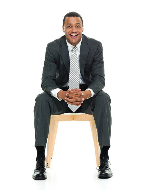 istock Smiling businessman sitting on chair 596083132