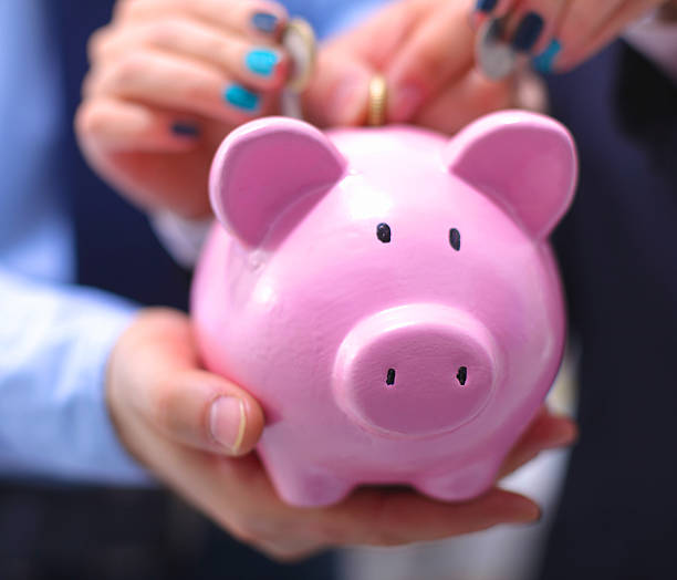 istock Businessman holding piggy box ,standing in office 596083396