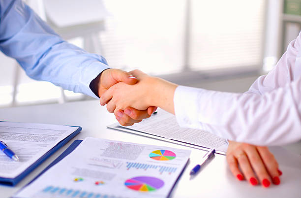 istock Business people handshake, sitting at the table 596084498