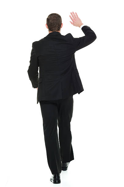 istock Rear view of businessman waving hand 596087096