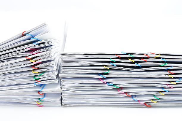 istock Colorful heart-shaped paperclip placed next to pile overload paperwork 596087368